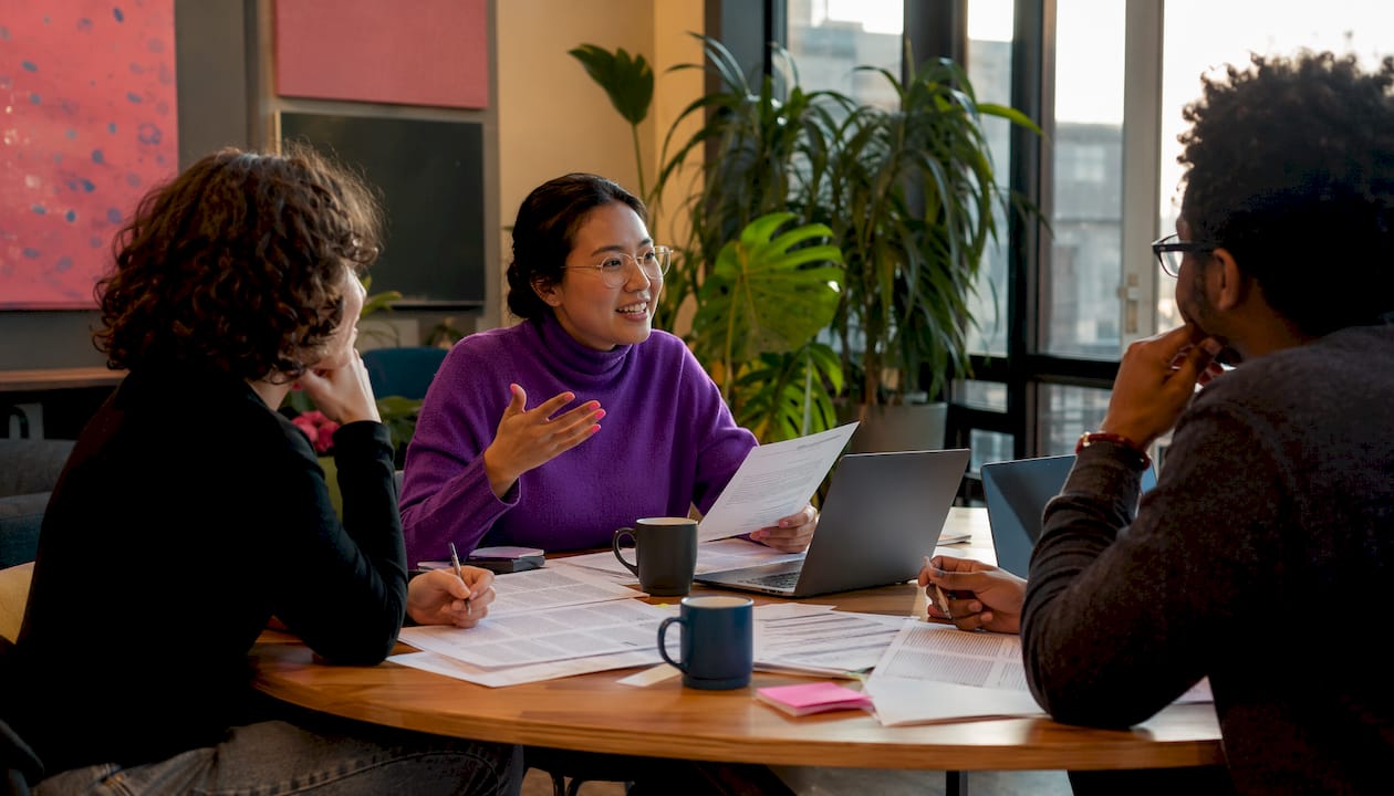 Researchers collaborating on literature review
