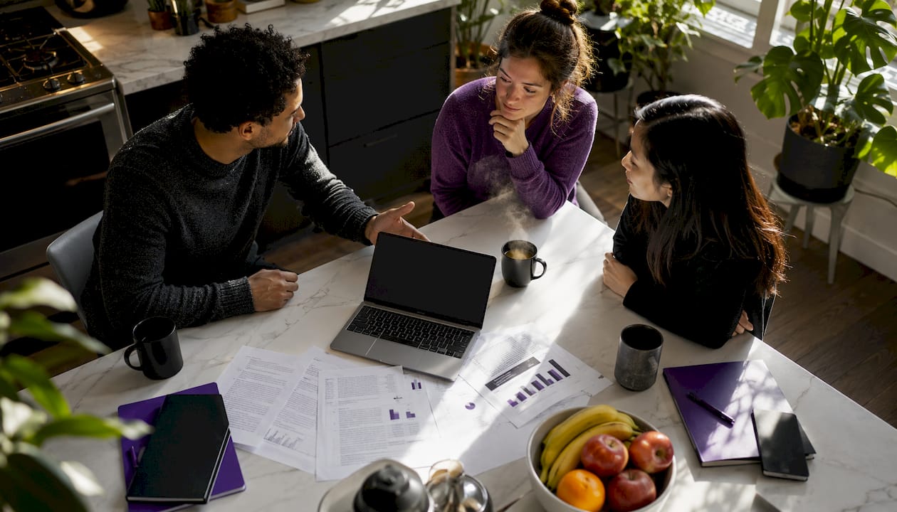 Research team discussing SLR platform at table