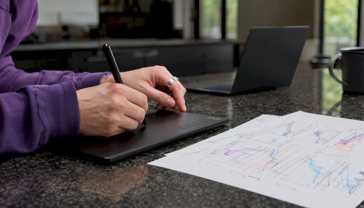 Hands annotating time-series figure in home study