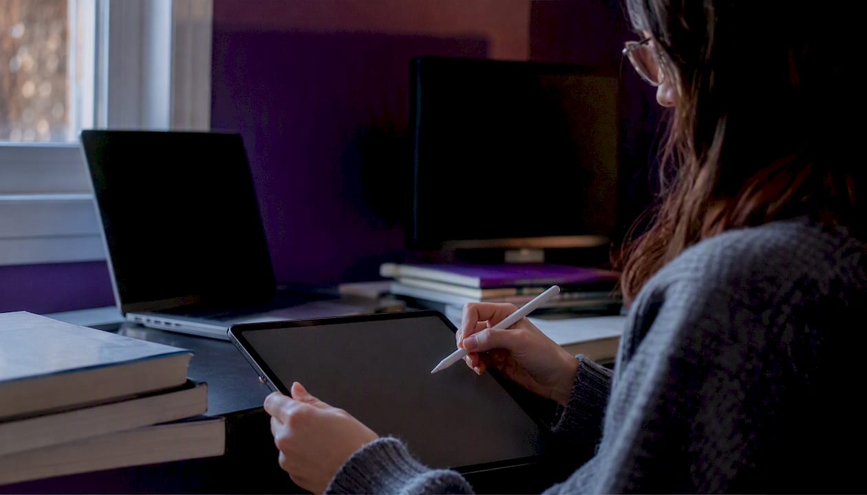 Researcher’s hand with stylus over tablet