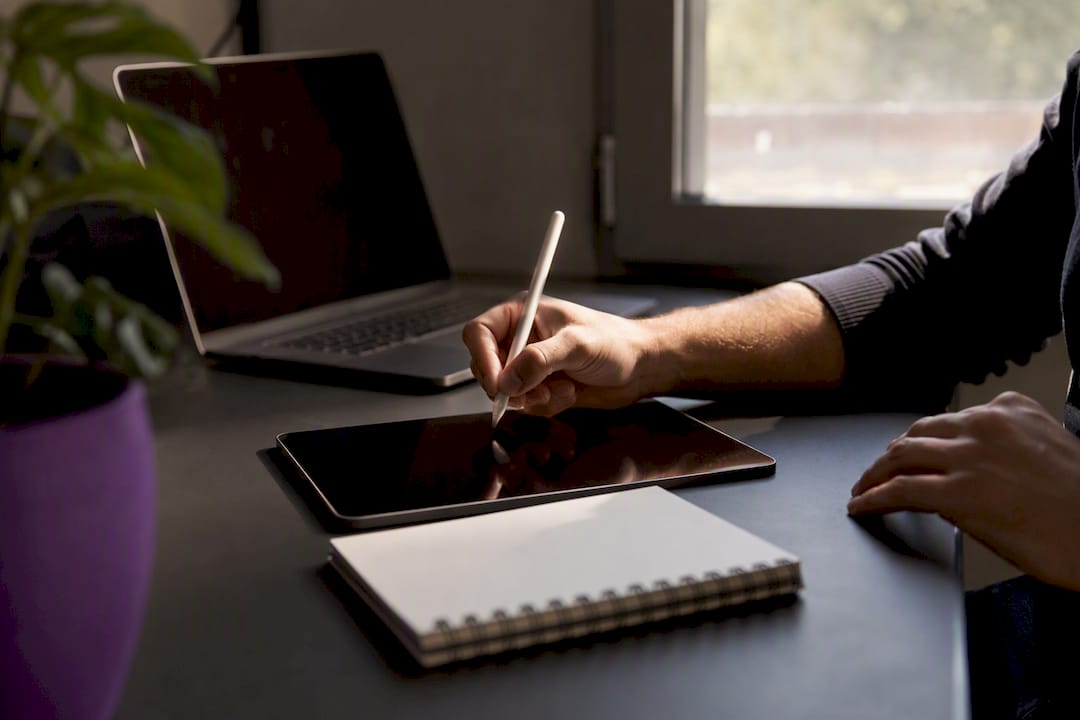 Hands poised to write next research step