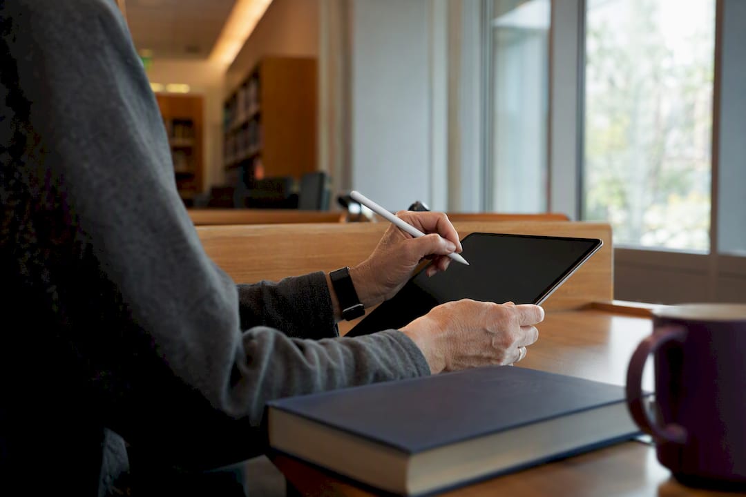 Faculty hands entering time diary on tablet