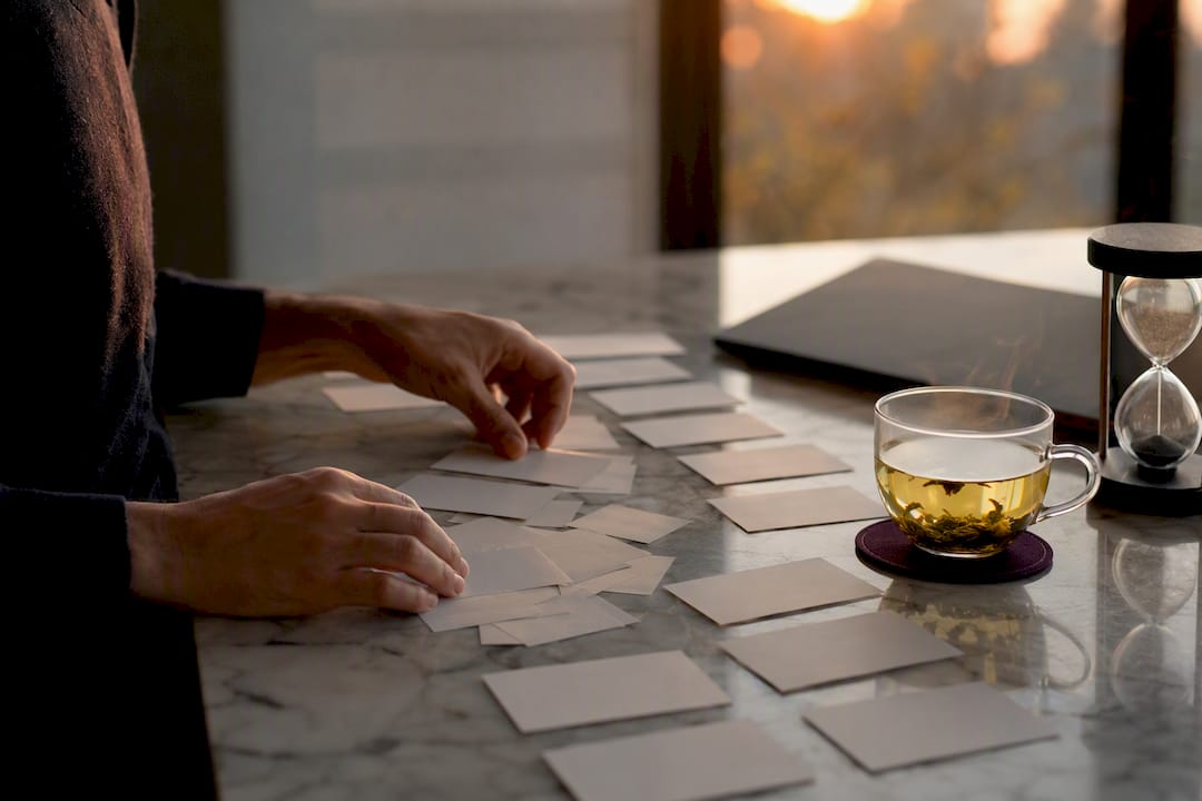 Hands sorting coded cards for data adjudication