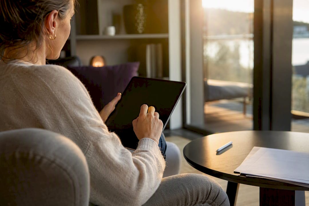 Hands navigating tablet for data extraction