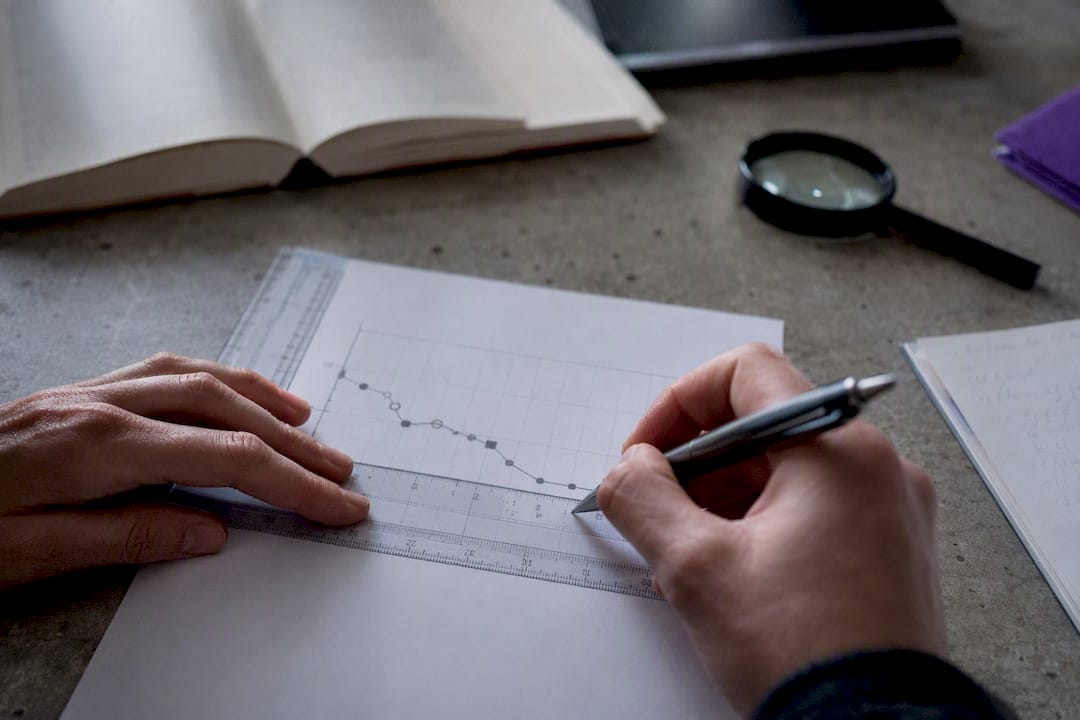 Hands calibrating scientific chart for figure digitization