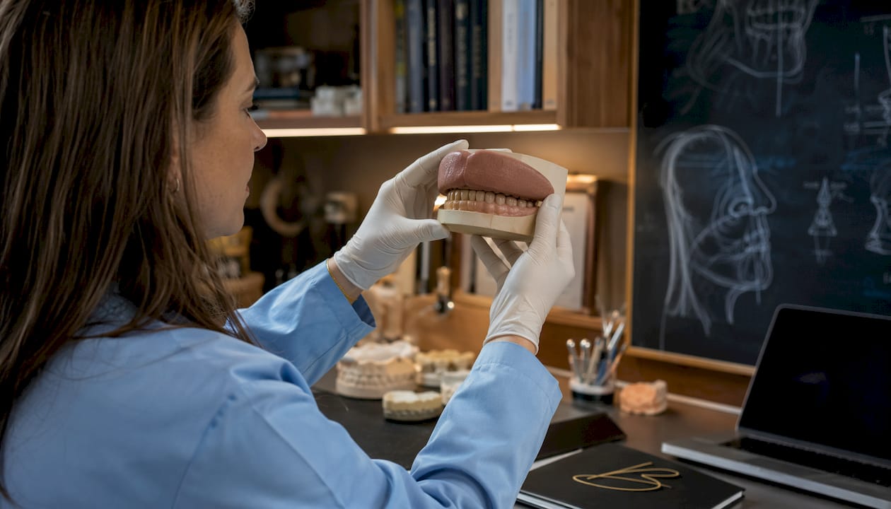 Hands holding dental model showing lip competence