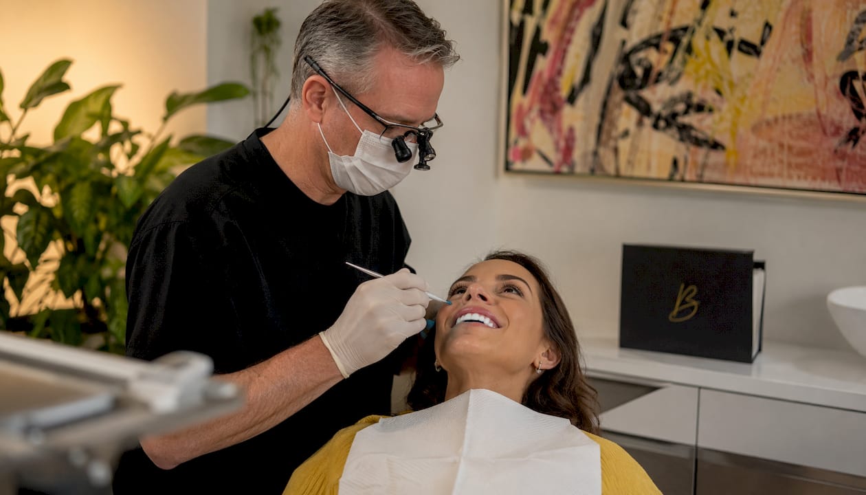 Dentist applying whitening gel in clinic