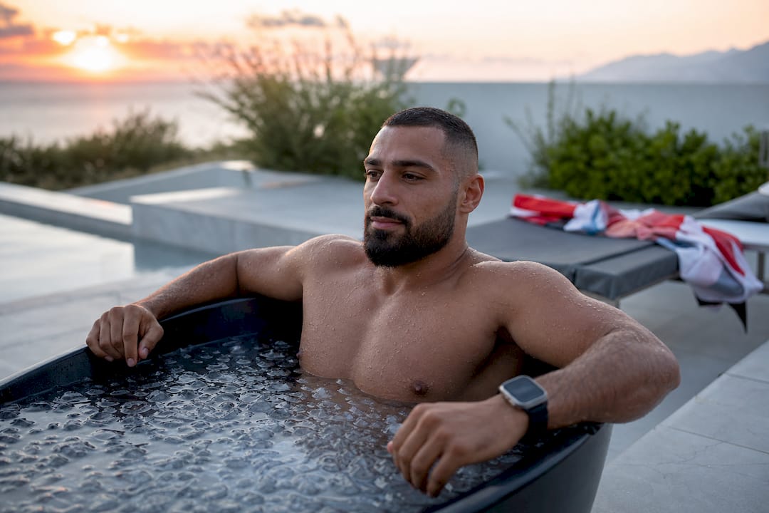 Athlete arms soaking in ice bath water