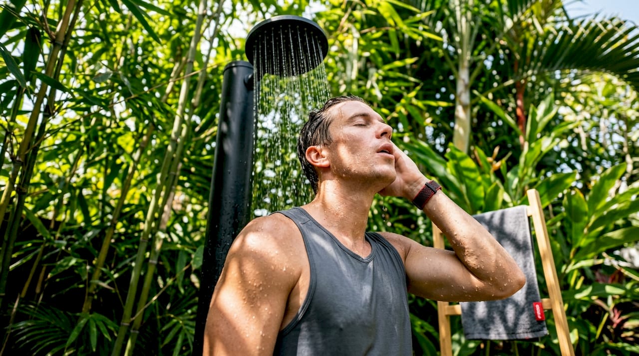 Athlete taking a cool post-workout shower