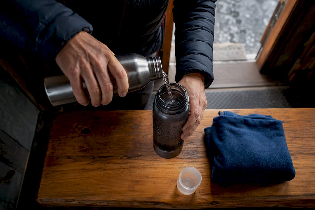Hiker pouring water after altitude illness