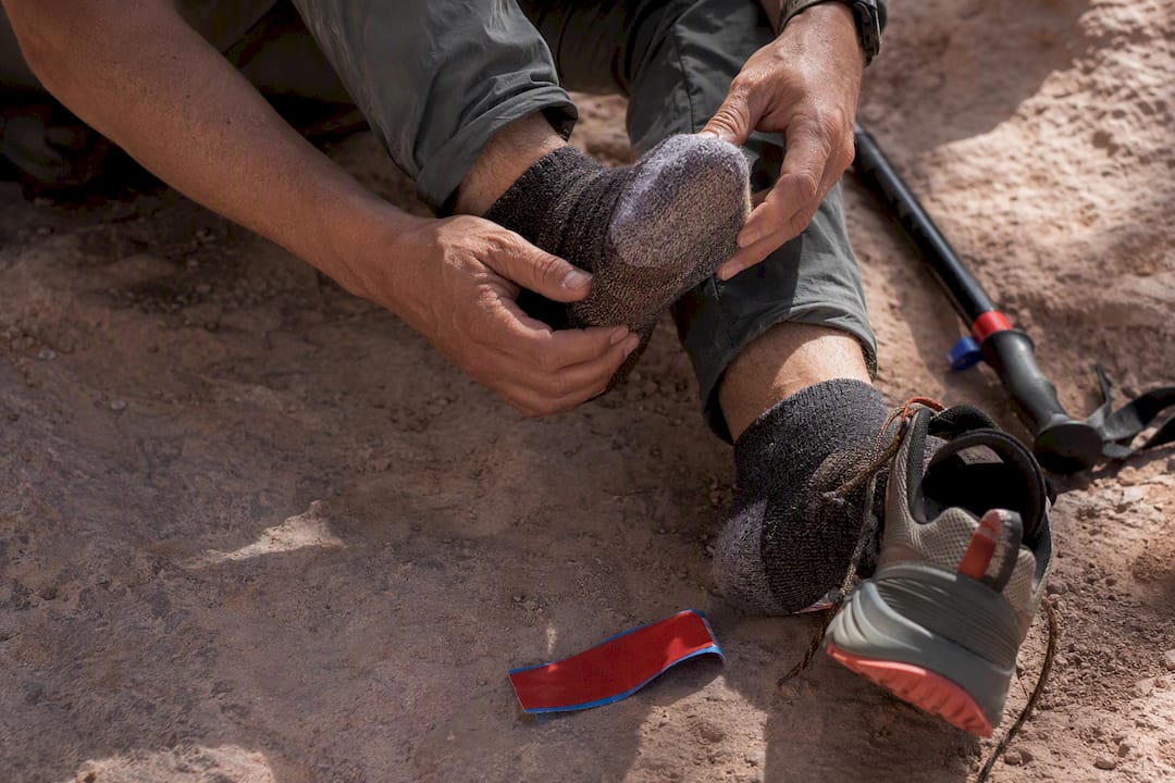 Hiker checking foot for a hot spot