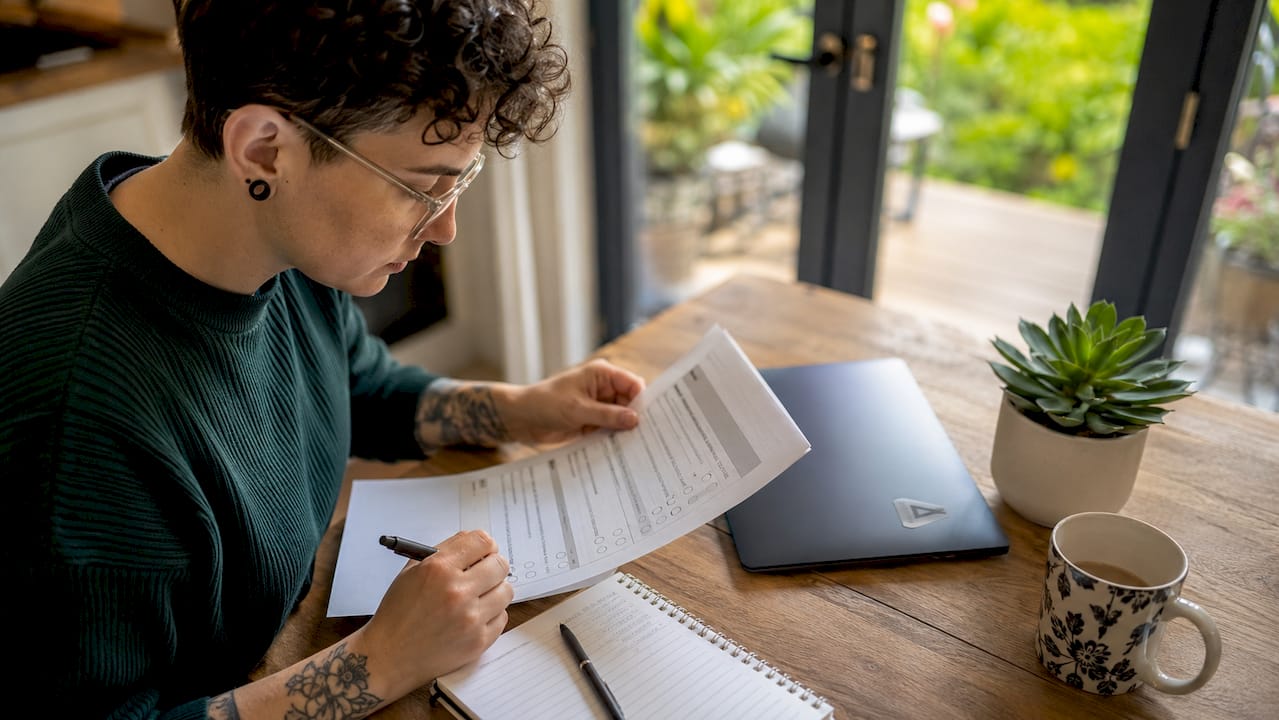 Web developer reviewing accessibility checklist at desk