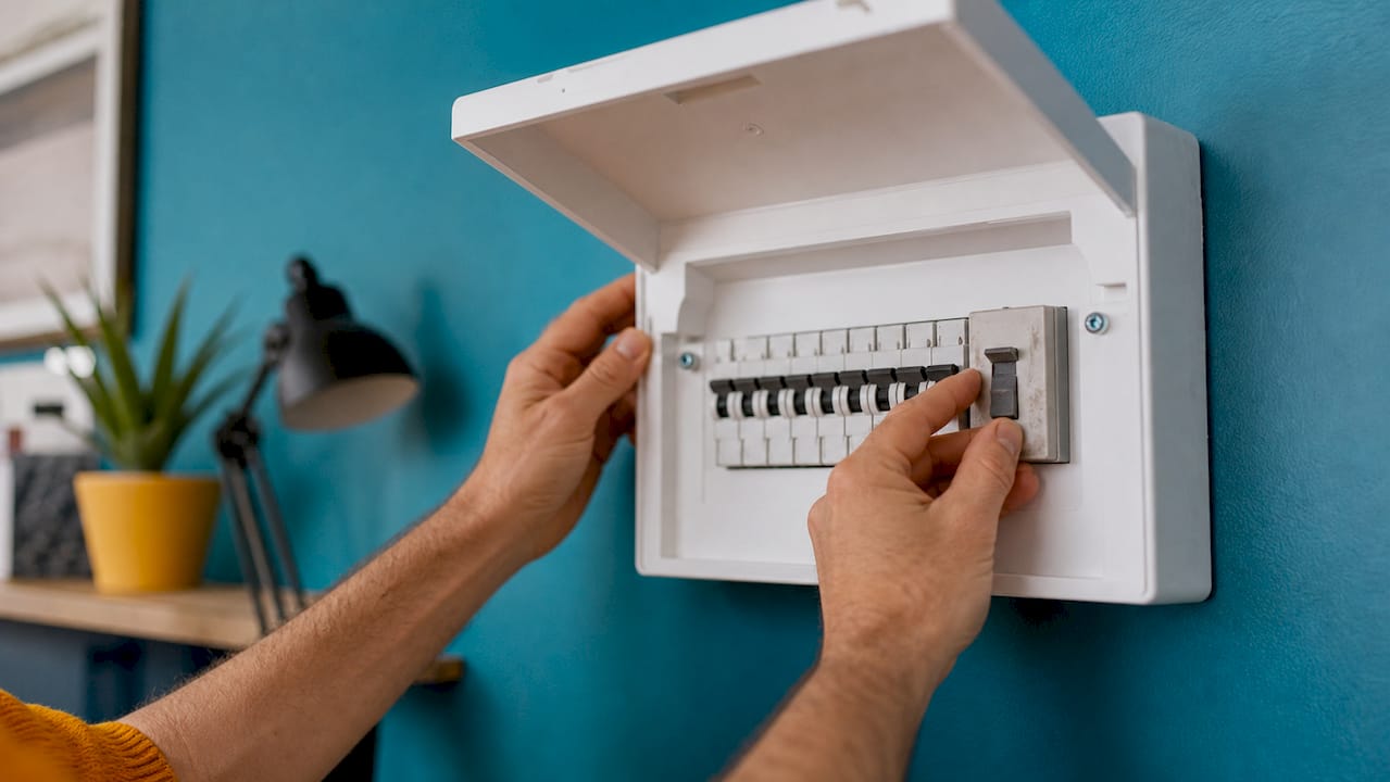Close-up of hands resetting isolator switch