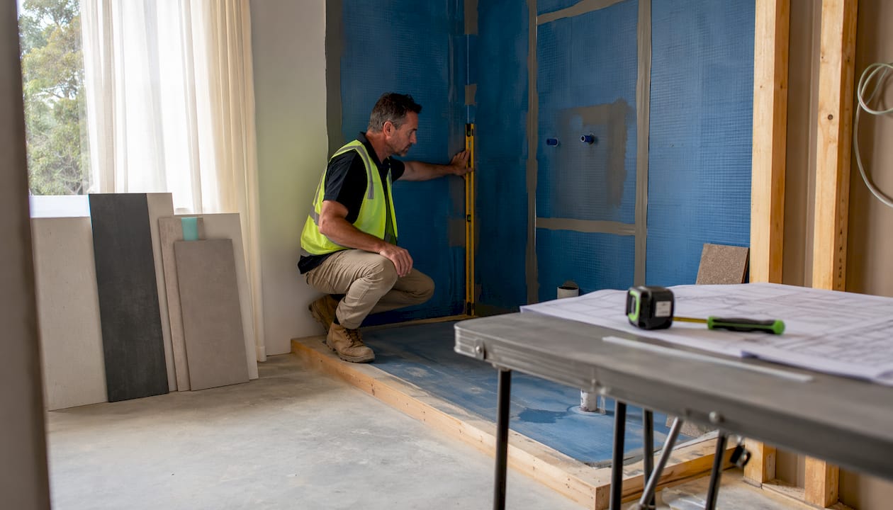 Builder inspecting wet area bathroom renovation