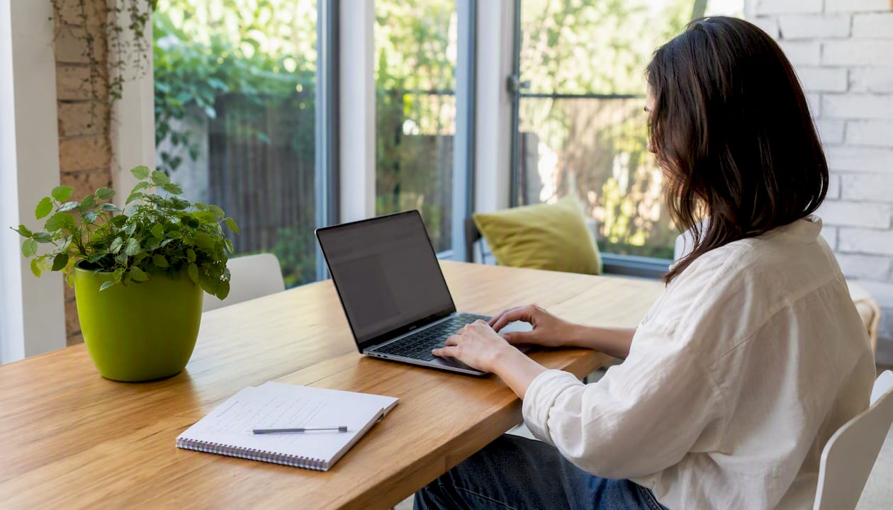 Homeowner reviewing extension cost tablet budget