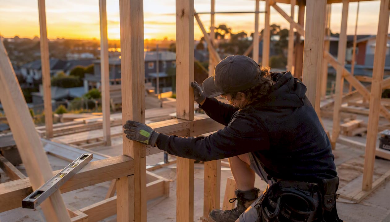 Hand inspecting timber framing in renovation