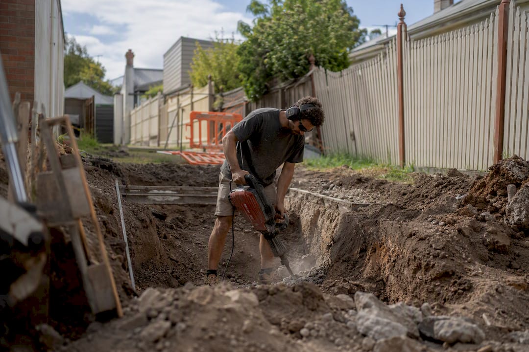 Worker jackhammering on Melbourne basement site