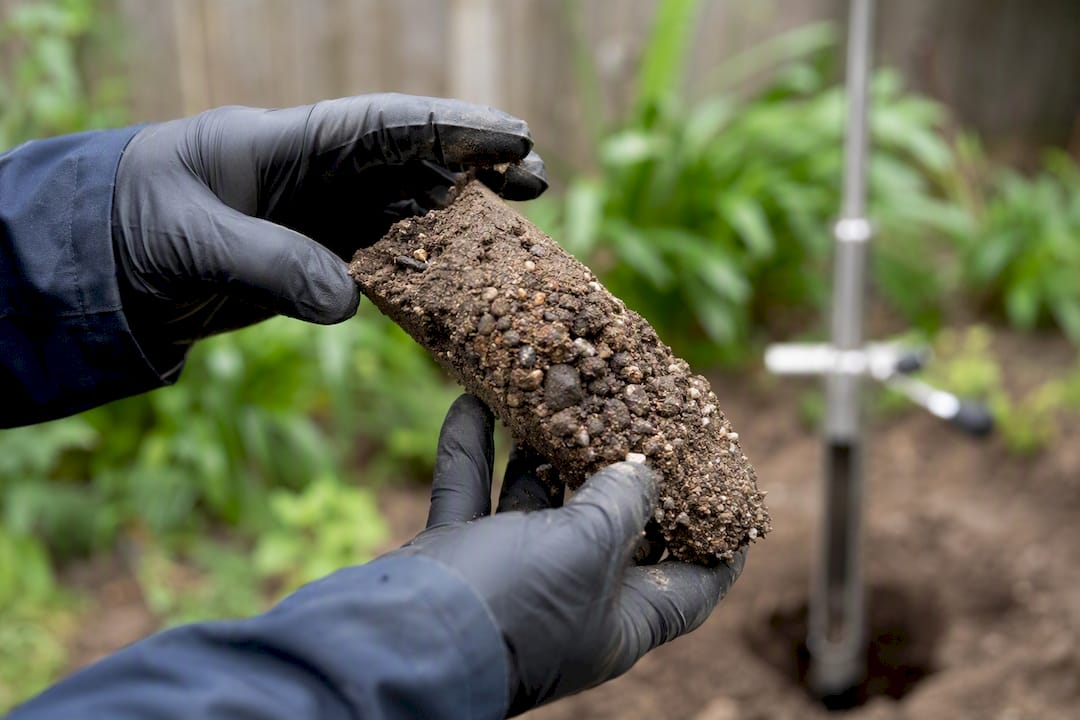 Hands holding soil sample for testing