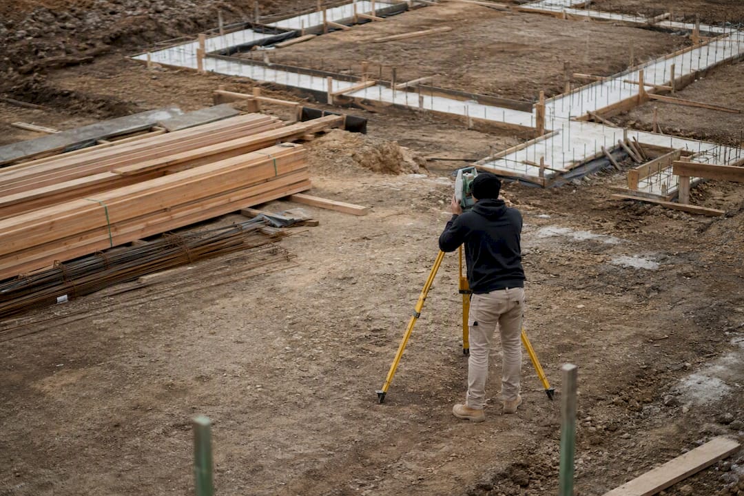 Surveyor measuring foundation on Melbourne build site