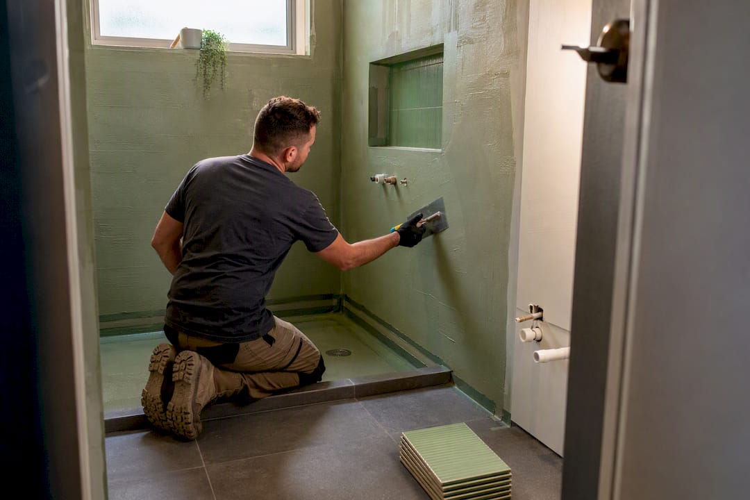 Waterproofing work inside a bathroom renovation