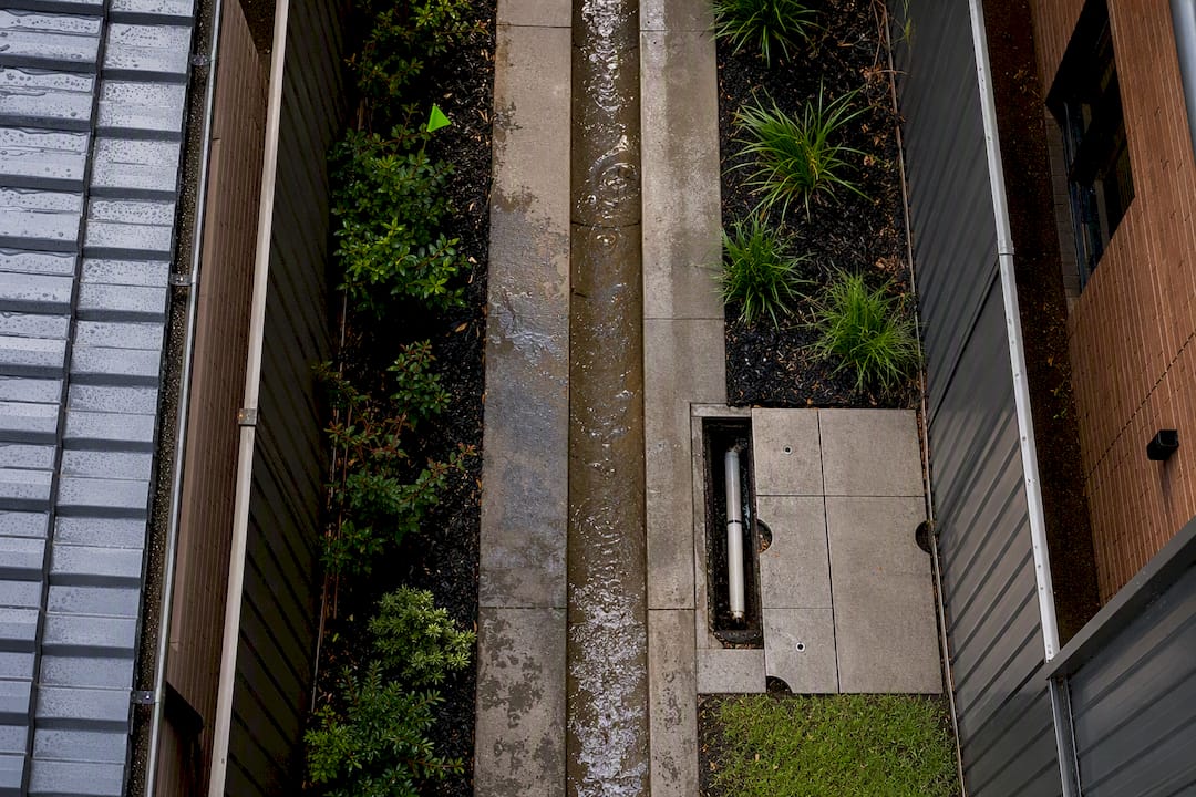 Open drainage and access corridor beside homes