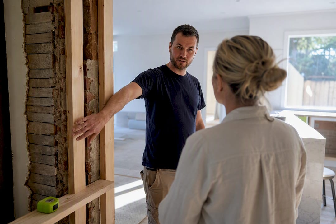 Builder and homeowner discussing renovation details