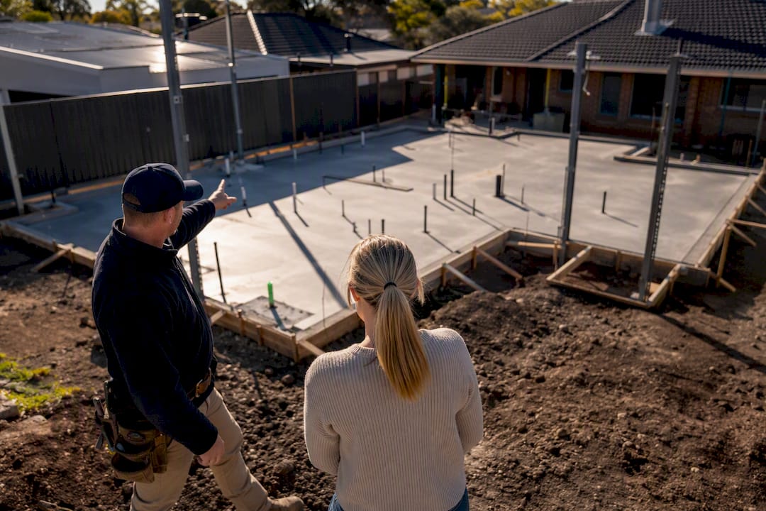 Builder reviewing staged extension construction