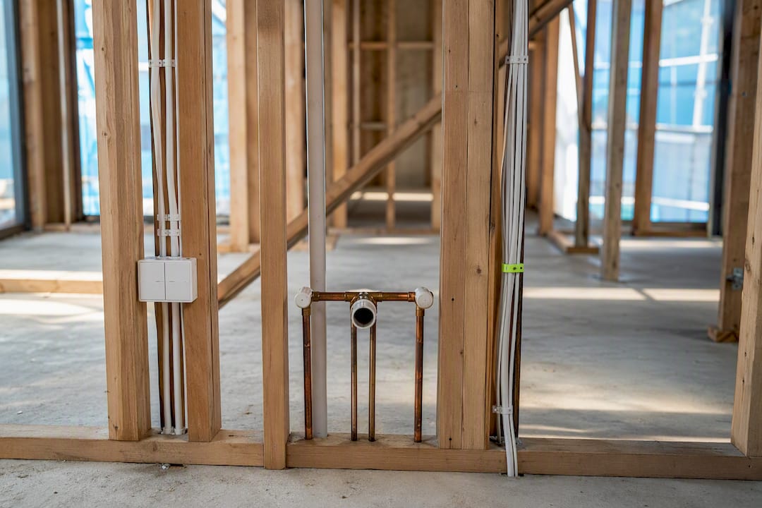 Plumbing and electrical rough-ins inside framed wall