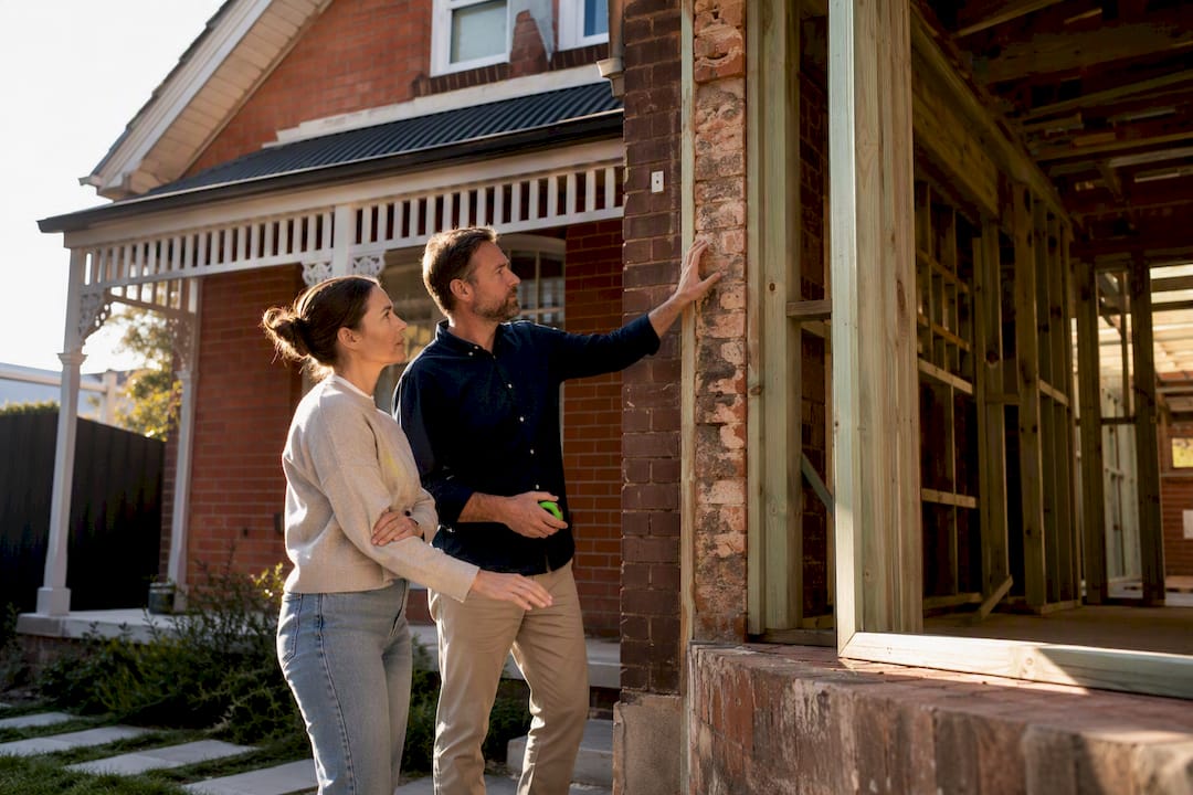 Homeowner inspecting Melbourne extension with builder