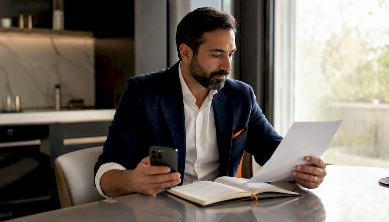 Hands verifying entertainer credentials by phone and paper
