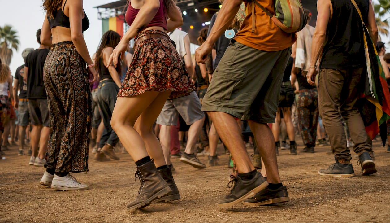 Diverse crowd dancing at reggae festival stage