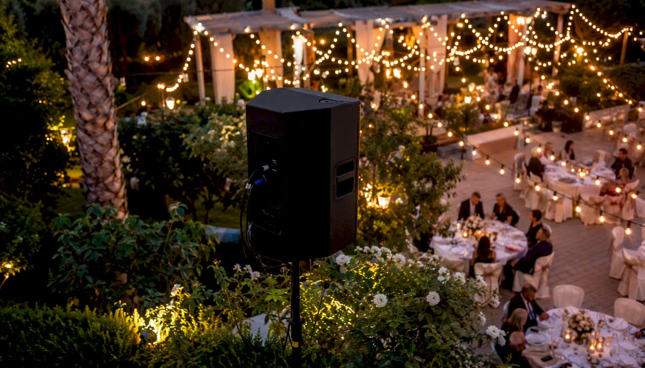 Outdoor PA speaker setup at evening event