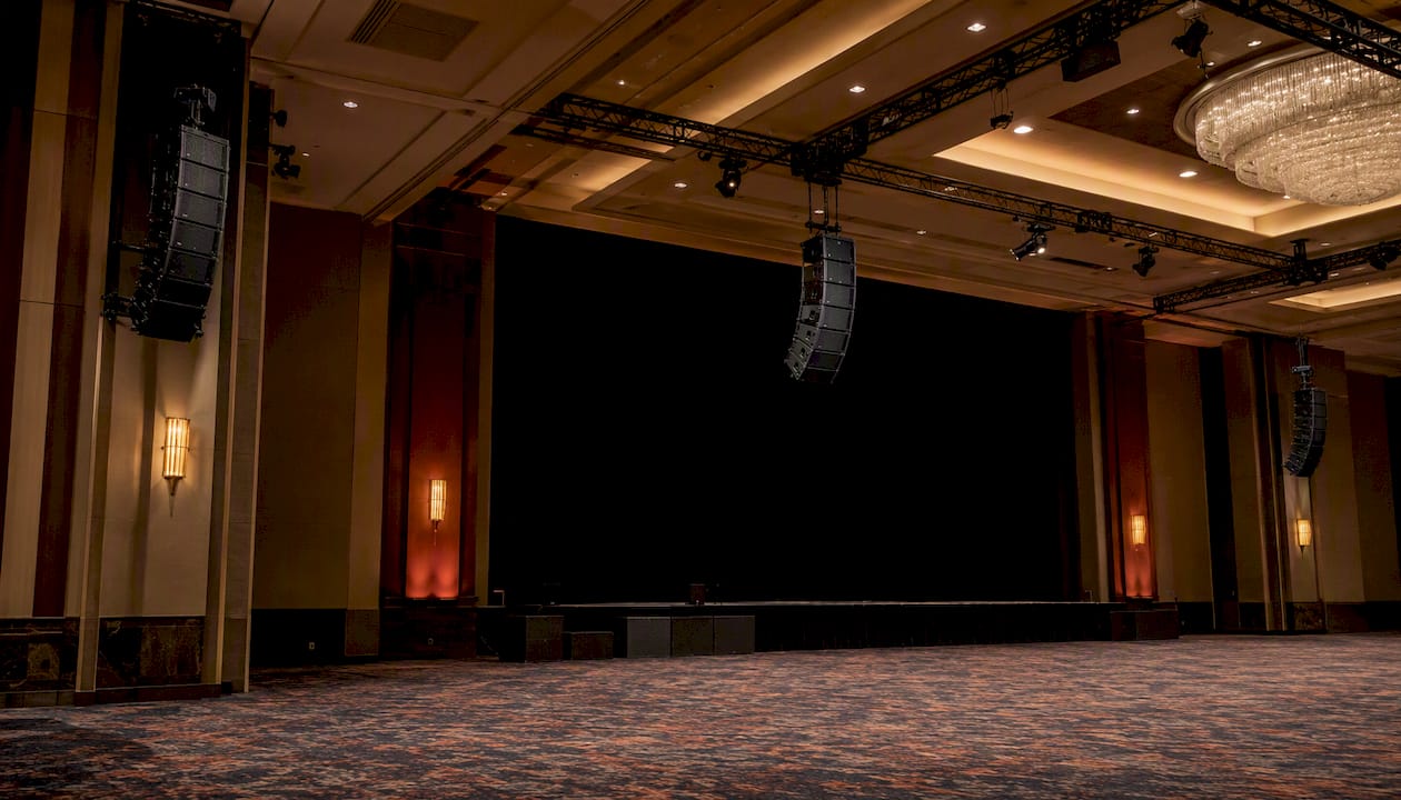 Line array speakers and subwoofers in a large ballroom