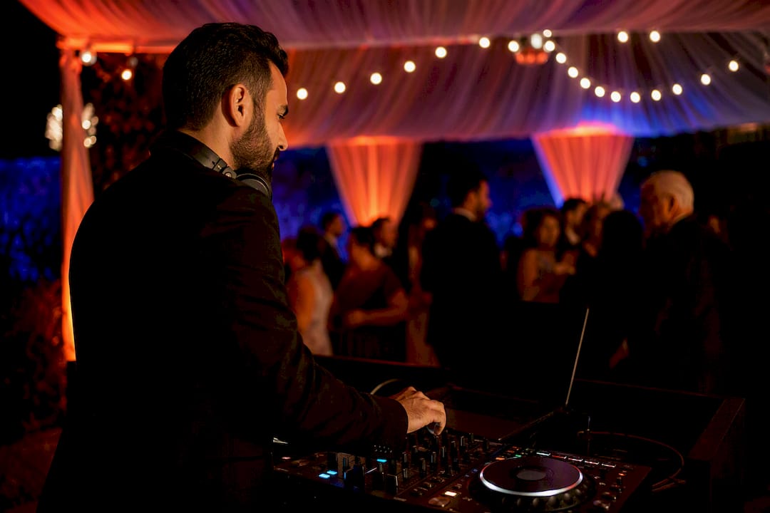DJ observing crowd reaction at wedding