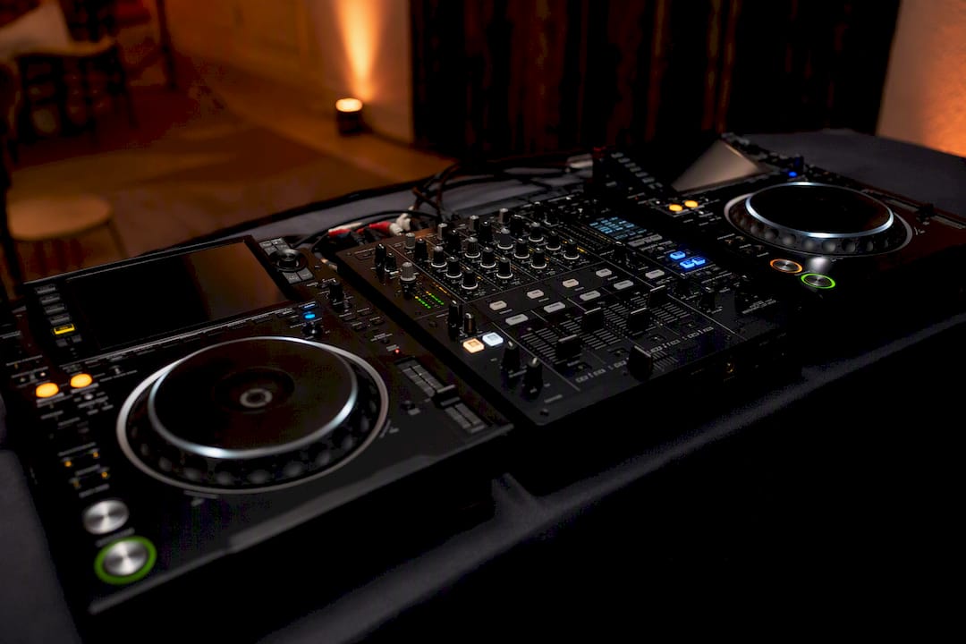 DJ mixer and CDJ decks on booth table