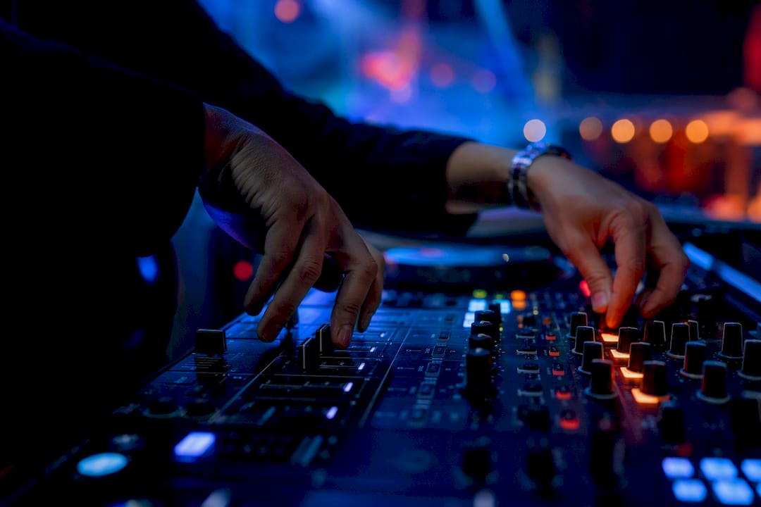 DJ hands adjusting tempo transition knobs