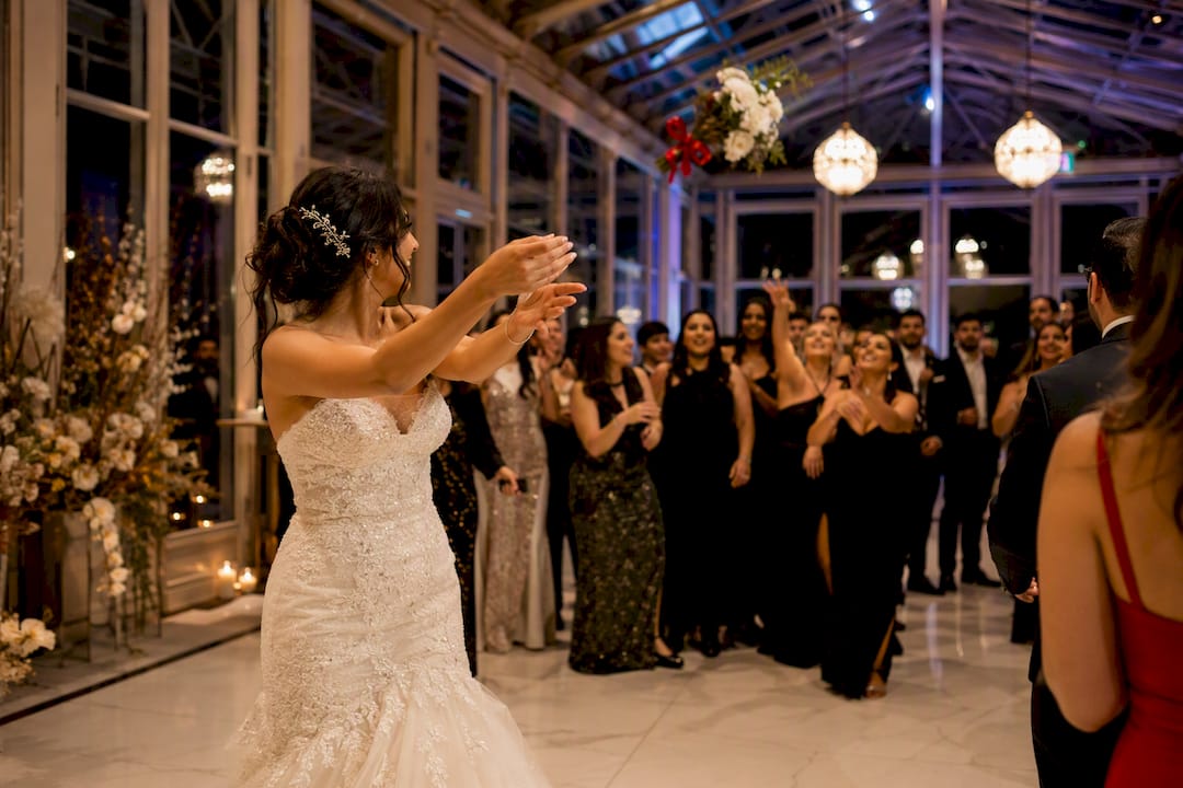 Guests reacting during a wedding bouquet toss