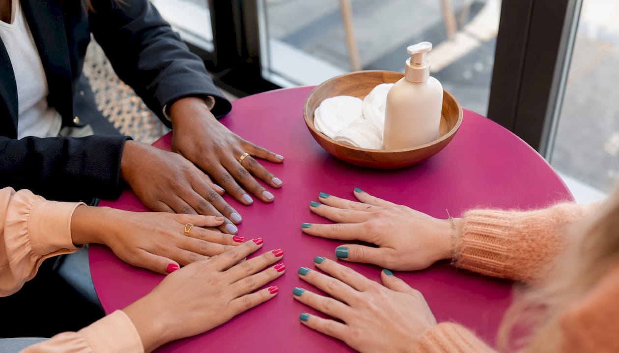 Verschillende handen met kleurrijke veganistische nagellak