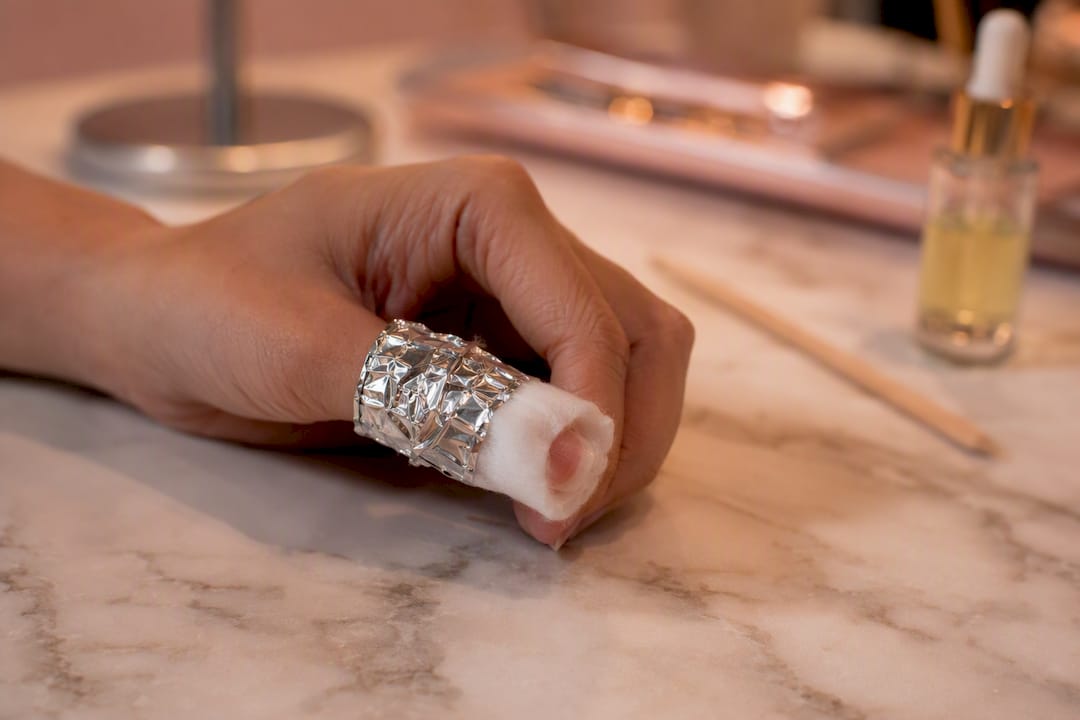 Vinger ingepakt met met aceton doordrenkte watten en folie