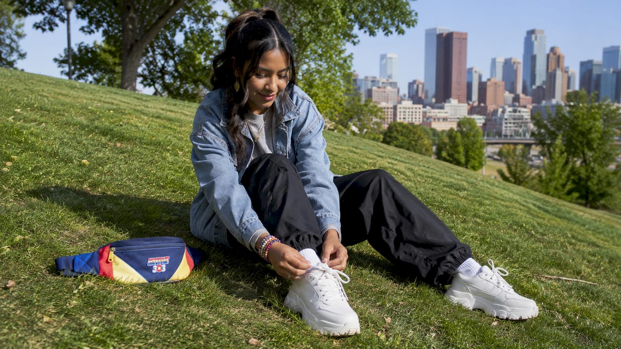 Woman tying sneakers in Denver streetwear outfit