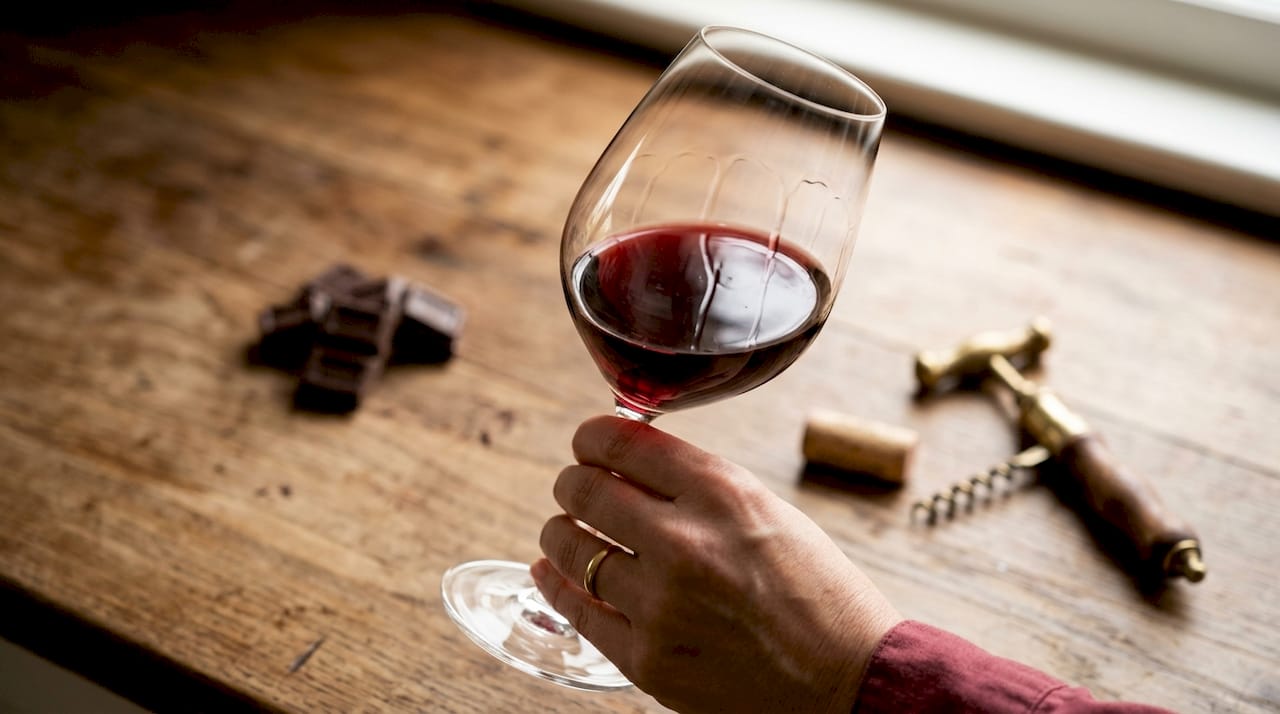 Close-up of red wine texture and wine glass