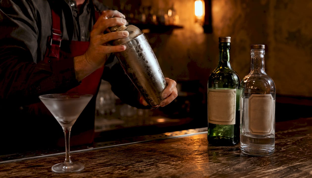 A Guide to Vermouth: What Every Wine Lover Should Know Bartender stirring martini with vermouth and gin