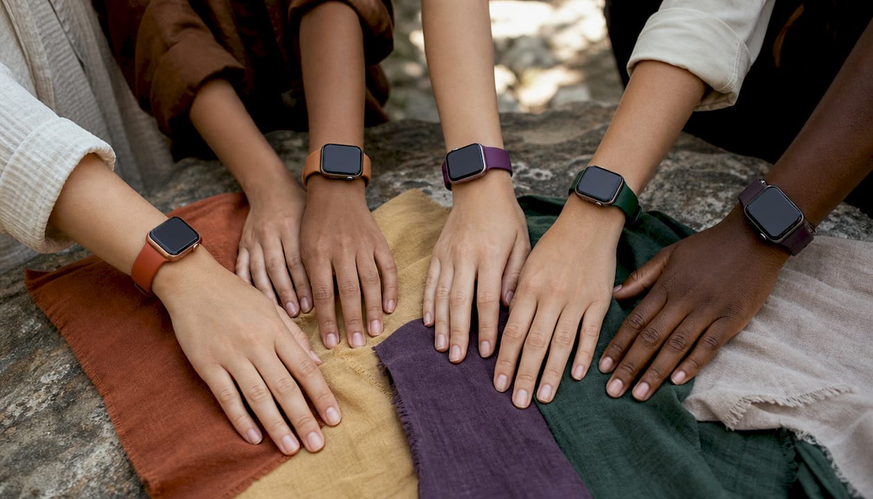 Multiple wrists with Apple Watch bands matching skin tones