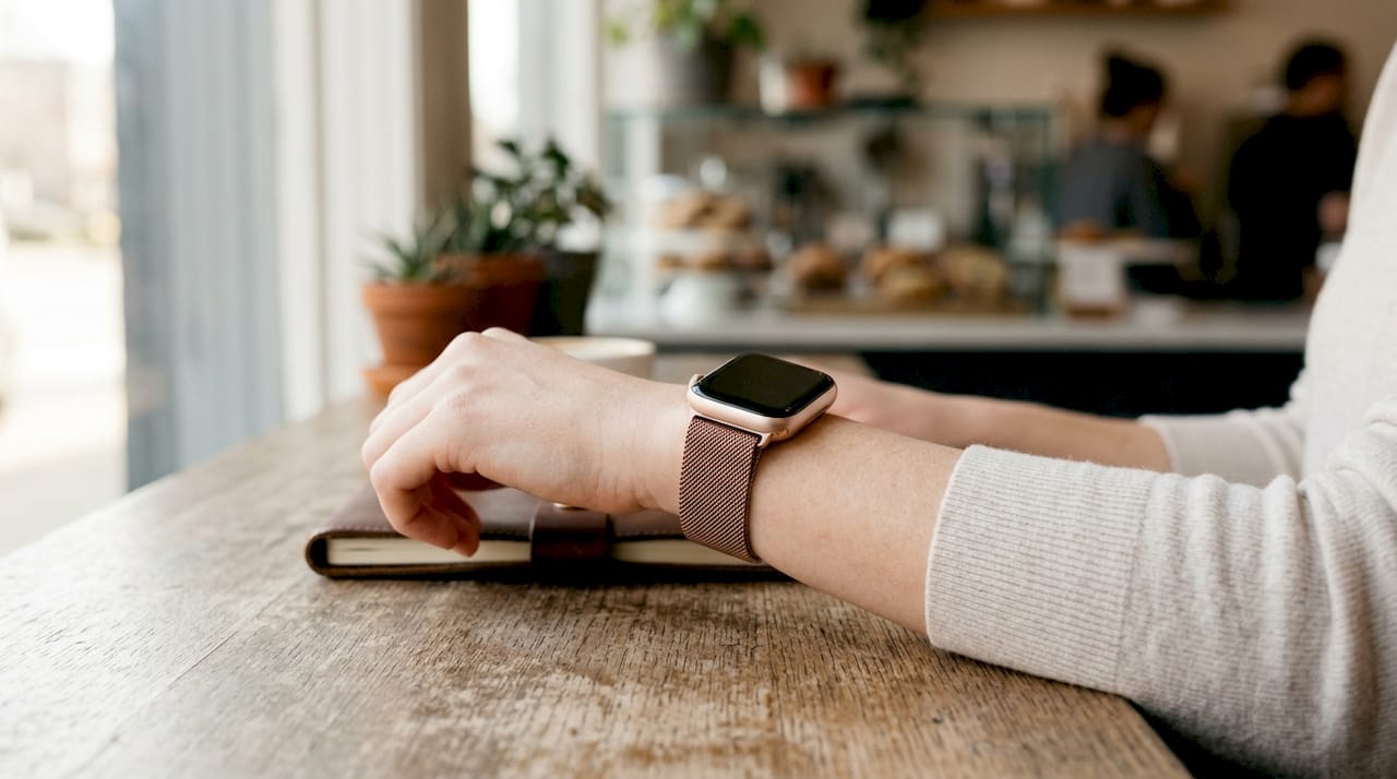 Rose gold Apple Watch band on fair skin wrist