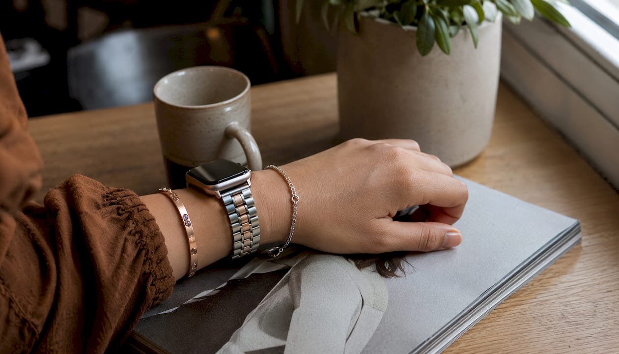 Overhead view of wrist with mixed metal watch band and bracelets