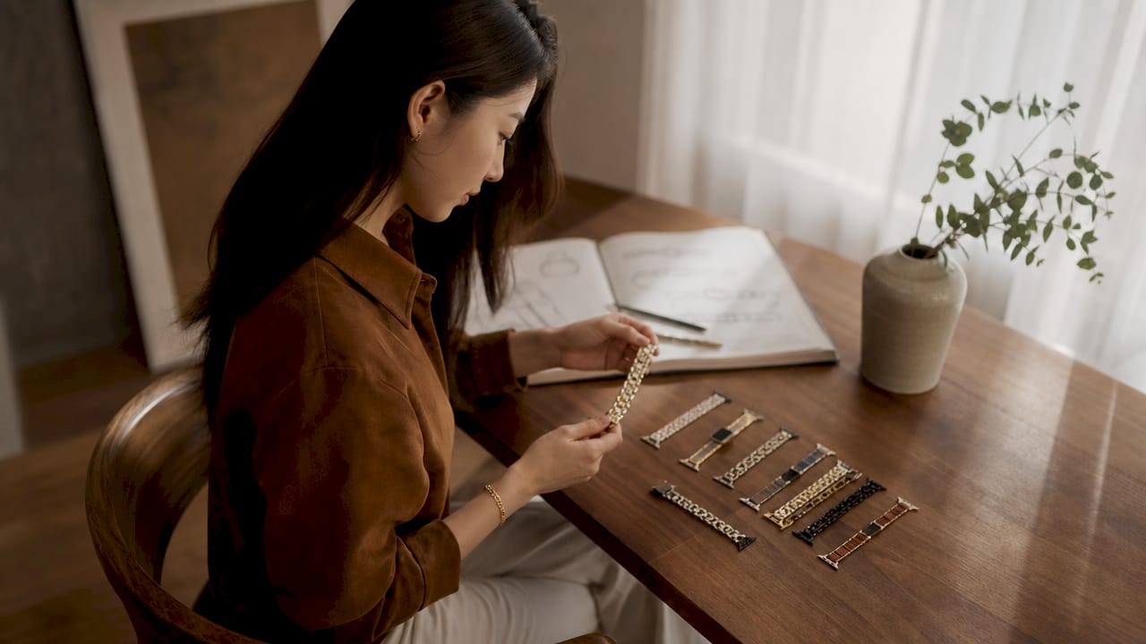 Woman comparing multi-chain watch bands at table