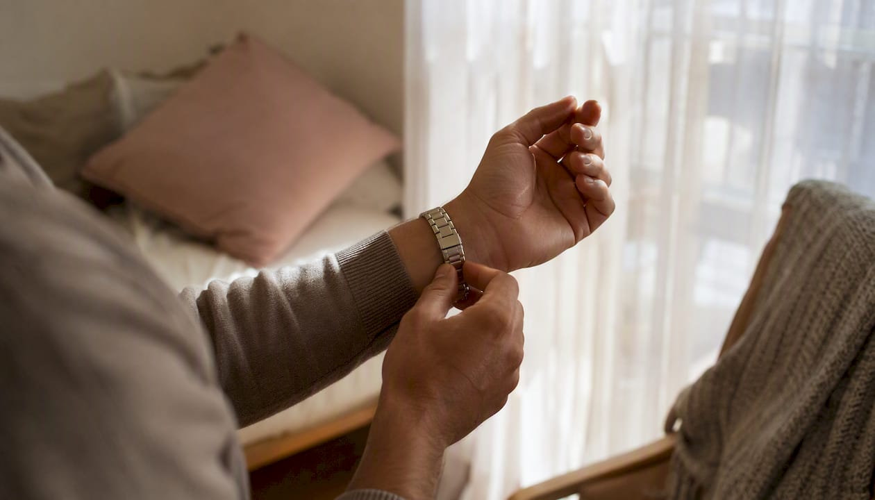 Hands wearing silver-finish metal bracelet