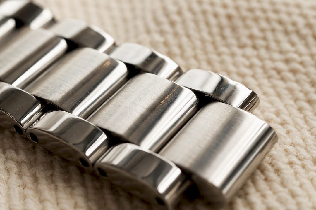 Close-up of polished stainless steel watch band links