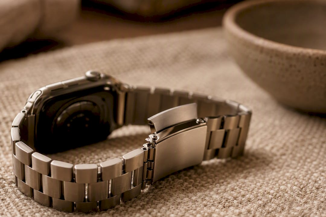 Close-up of metal watch band clasp and links