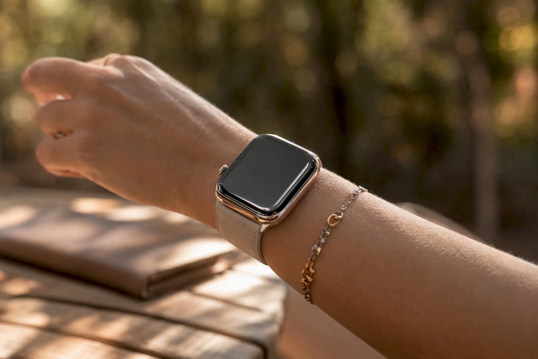 Wrist with watch featuring polished metal bezel